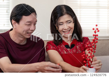 Elderly couple celebrating chinese new year in cozy home joyful moments warm atmosphere intimate viewpoint 124928776