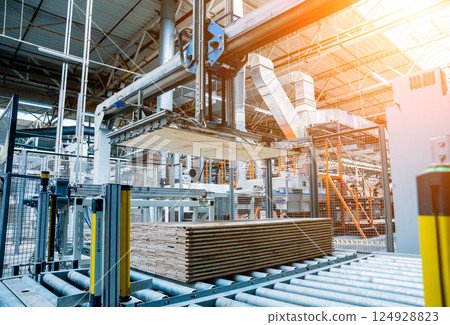 Production line of the wooden floor factory. CNC automatic woodworking machine. 124928823