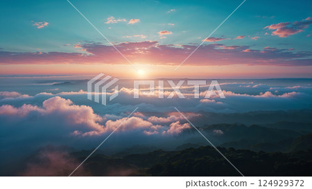 Sun shining through clouds over majestic green hills at sunrise 124929372