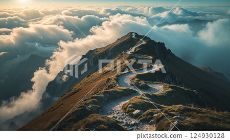 Winding mountain path leading above the clouds at sunset Winding mountain path leading above the clouds at sunset 124930128