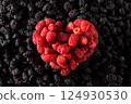 heart of raspberries on black berry texture 124930530