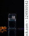 perfume bottle on a black background flowers spring aroma 124930542