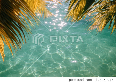 Vibrant underwater view with sunlight filtering through tropical leaves in clear blue water 124930947