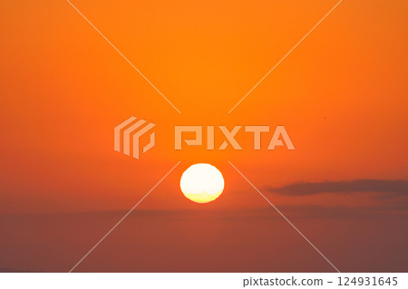Sunrise view from Malaga seaside city in Andalusia, Spain, Europe. Fiery sunrise with a bright, large sun dominating the orange sky. A perfect end to the day. 124931645