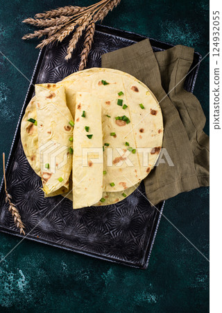 Lavash flat bread on green background Lavash flat bread on green background 124932055