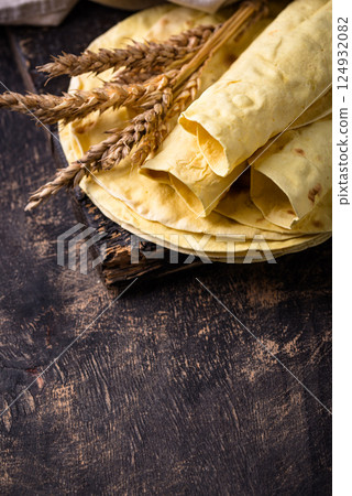 Lavash flat bread on green background Lavash flat bread on green background 124932082