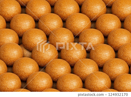 Golden round pastries arranged in uniform pattern on display 124932170