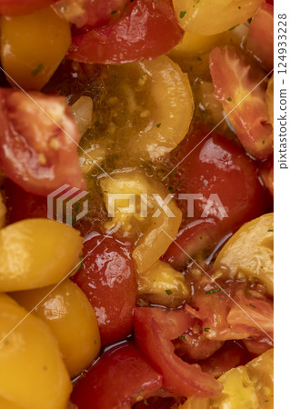 preparation of salad from sliced tomatoes with spices and oil, red and yellow tomatoes preparation of salad from sliced tomatoes with spices and oil, red and yellow tomatoes 124933228