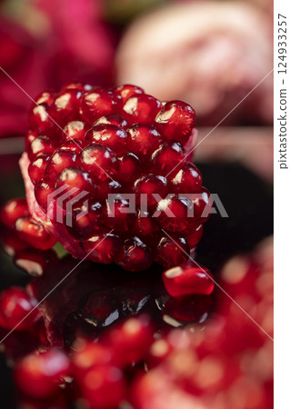pomegranate seeds on the table, peeled ripe red pomegranate, closeup 124933257