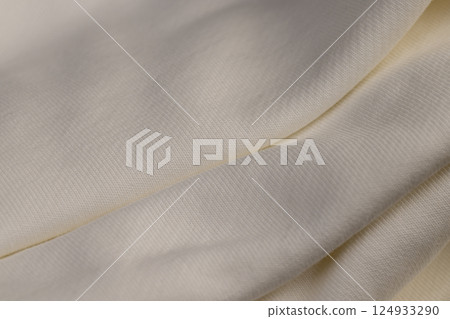 Crumpled cotton for the production of clothing and other items, natural cotton yarn material closeup Crumpled cotton for the production of clothing and other items, natural cotton yarn material closeup 124933290