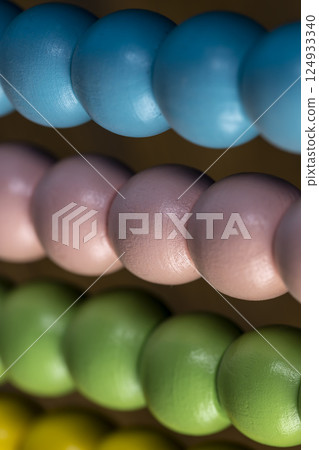 colorful wooden beads on abacus for children's play, wooden children's abacus for learning and development 124933340