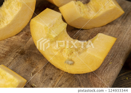pumpkin closeup, orange pumpkin fruit details cut into pieces for cooking 124933344