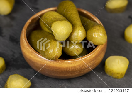 green pickles on the kitchen table, cut small, crispy green cucumbers green pickles on the kitchen table, cut small, crispy green cucumbers 124933367