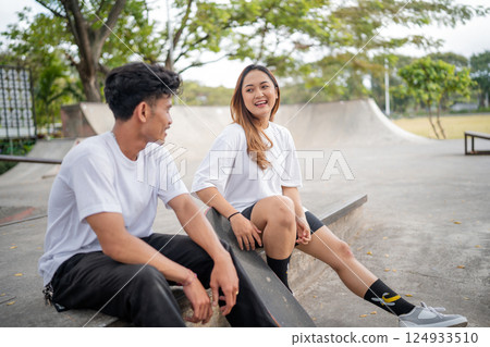 A Group of Young Friends Happily Enjoying Their Time Together at the Skatepark A Group of Young Friends Happily Enjoying Their Time Together at the Skatepark 124933510