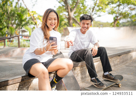 Joyful Moments Friends Happily Enjoying Their Time Together at the Skate Park Joyful Moments Friends Happily Enjoying Their Time Together at the Skate Park 124933511