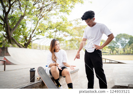 Skateboarders Having an Engaging Conversation at the Local Skate Park Together Skateboarders Having an Engaging Conversation at the Local Skate Park Together 124933521