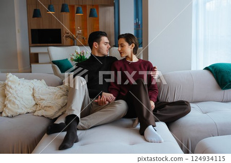 Couple sharing a quiet moment on a cozy sofa in a modern living room Couple sharing a quiet moment on a cozy sofa in a modern living room 124934115