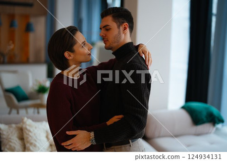 Couple sharing a tender moment in a modern living room setting 124934131