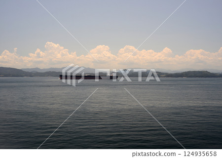A tanker passing a ferry boat off the coast of Sanuki 124935658