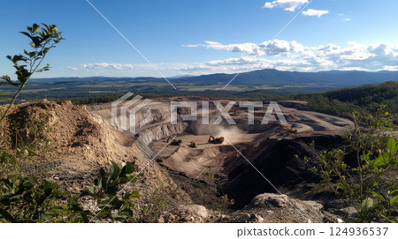 massive open pit mine with terraced excavation and dust clouds 124936537