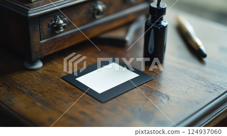 vintage workspace featuring handmade calligraphy card, ink bottle, and pen vintage workspace featuring handmade calligraphy card, ink bottle, and pen 124937060