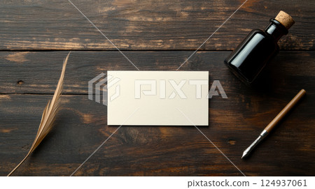 Handmade calligraphy card with ink bottle and feather on wooden table Handmade calligraphy card with ink bottle and feather on wooden table 124937061