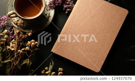 cozy scene featuring hardcover notebook, tea, and dried flowers cozy scene featuring hardcover notebook, tea, and dried flowers 124937070