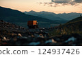 garbage truck unloading waste into landfill surrounded by mountains at sunset 124937426