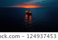 giant oil drilling rig illuminated at sunset over ocean 124937453