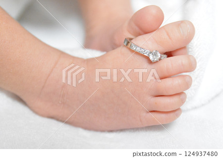Commemorative photo of mother's engagement ring on baby's toe Commemorative photo of mother's engagement ring on baby's toe 124937480
