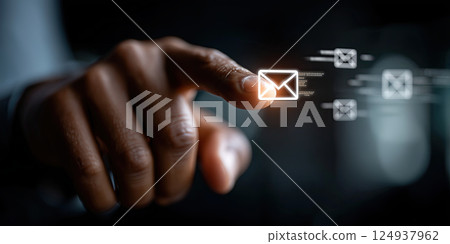 hand touching glowing email icon on digital screen, symbolizing communication 124937962