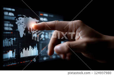 hand interacting with glowing digital financial graph on dark screen 124937980
