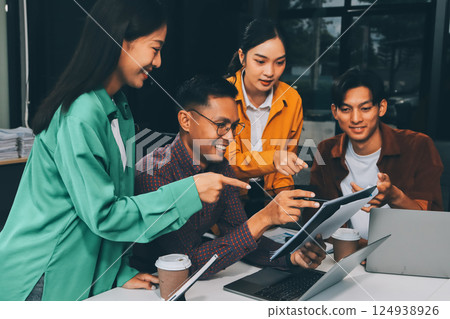 Business team showing unity with their hands together, Close up top view of young business people putting their hands together. people together to work as team to ensure the success of the business 124938926