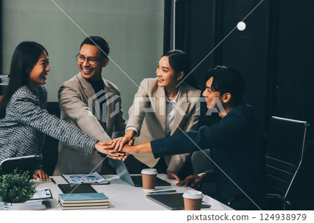 Business team showing unity with their hands together, Close up top view of young business people putting their hands together. people together to work as team to ensure the success of the business 124938979