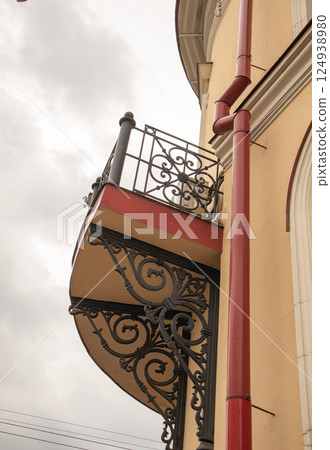 Bottom view of the balcony with wrought iron railing, vertical 124938980