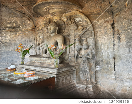 Buddha statue in the Gal Vihara cave, behind the wire fence, Polonnaruwa ruins, World Heritage Site Buddha statue in the Gal Vihara cave, behind the wire fence, Polonnaruwa ruins, World Heritage Site 124939556