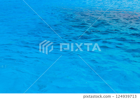 Blue water texture background. Surface of sea or ocean Blue water texture background. Surface of sea or ocean 124939713