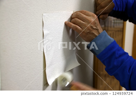 Repairing a hole in a wall 124939724