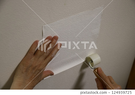 Repairing a hole in a wall 124939725