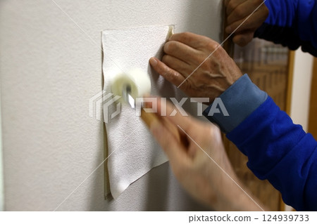 Repairing a hole in a wall Repairing a hole in a wall 124939733