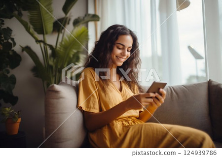 Joyful Young Latin Woman Engaging with Her Phone on a Home Sofa. Generative ai 124939786