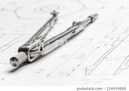 Lying drawing compasses 124939898