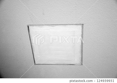 Repairing a hole in a wall (monochrome) 124939931