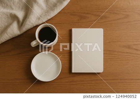 Morning on a wooden desk with notebook and coffee 124940052