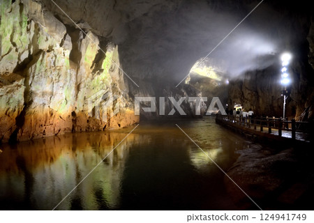 Tourists walking along the underground river from the entrance of Akiyoshi Cave, Akiyoshidai, Chugoku region, Miya City, Yamaguchi Prefecture (1) 124941749