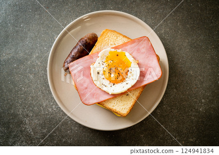 bread toasted cheese topped ham and fried egg with pork sausage bread toasted cheese topped ham and fried egg with pork sausage 124941834