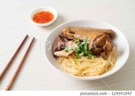 dried noodles with braised duck in white bowl 124941847