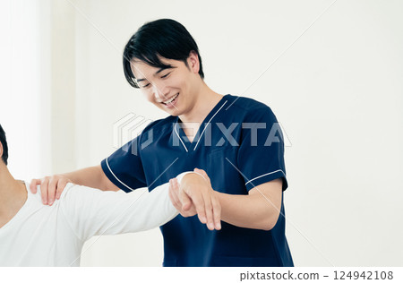 A male chiropractor performing a treatment A male chiropractor performing a treatment 124942108