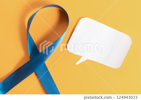 Blue awareness ribbon and speech bubble on an orange background. 124943015
