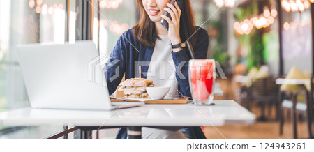 Adult asian woman working at cafe digital nomad talking communication with wireless technology Adult asian woman working at cafe digital nomad talking communication with wireless technology 124943261